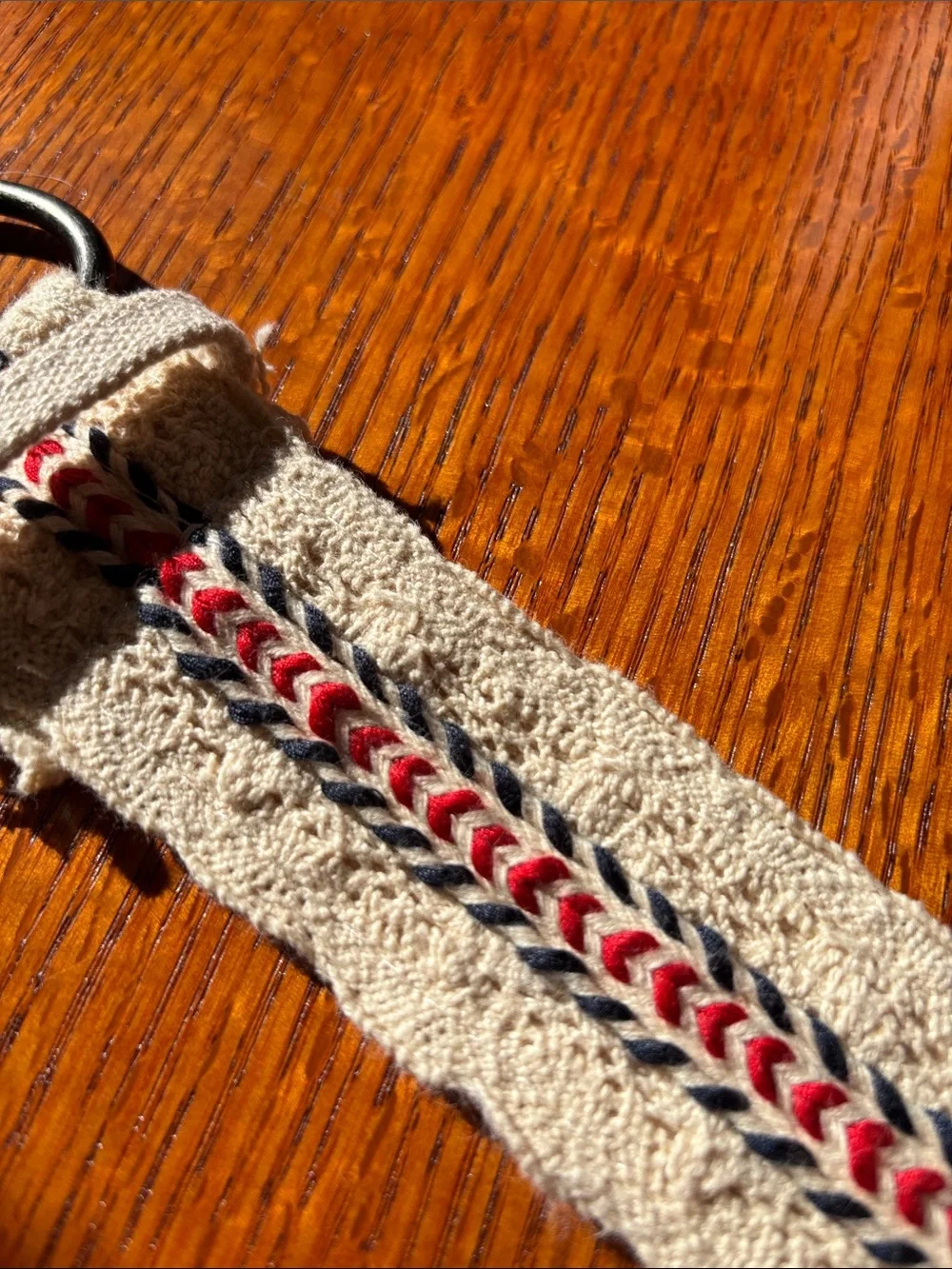 Canvas cream color crochet belt with red and blue embroidered accents. Size 7